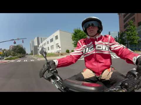 Riding Electric Scooter across Charlotte Uptown